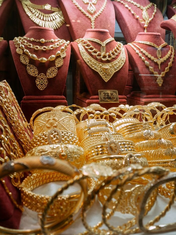 Luxurious gold jewelry display featuring necklaces and bracelets in an Istanbul store.